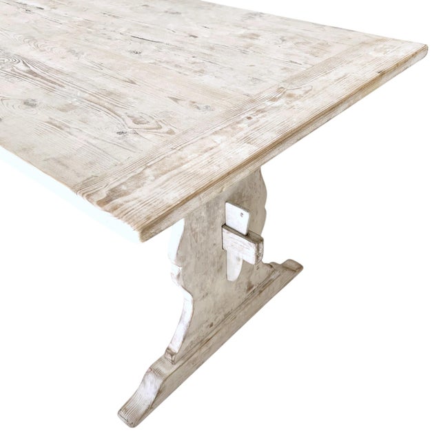 A 19th-century Swedish painted white farm table embodies the rustic elegance and practicality of Scandinavian design. This...