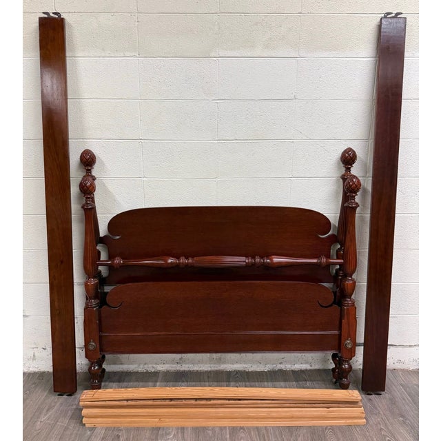 This is a gorgeous vintage full size Duncan Phyfe style mahogany bed featuring carved pineapple or pinecone finials,...