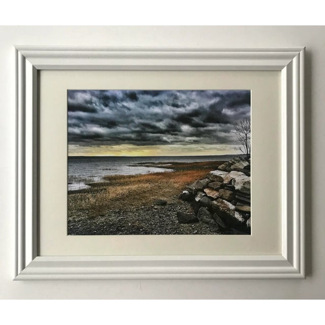 This waterscape art photo features a longing glance at Greenwich Beach on a dramatic, overcast day. Presented in a white...