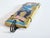 Decorative wall tile with a colorfully glazed relief of a stylized figure from the Commedia dell'arte, executed in vibrant...