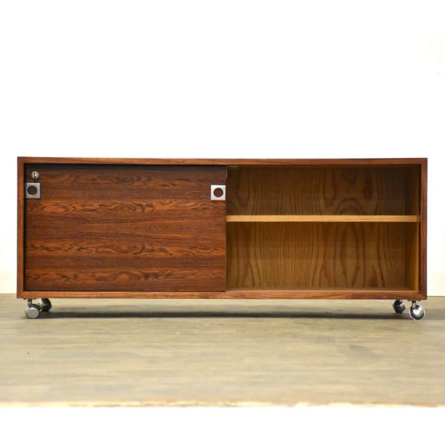 A mid century modern rosewood credenza cabinet or TV console designed by Bodil Kjaer for Pedersen and Sons with chrome...