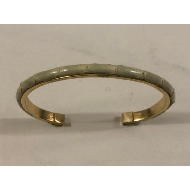 This beautiful 1980s Celery Green Snakeskin Gold Bangle Bracelet will be a subtle yet sophisticated option from day to...