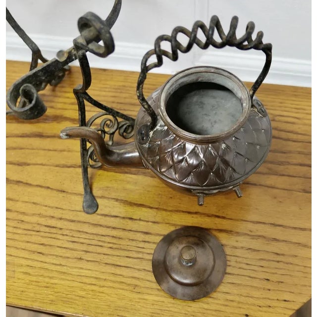 19th Century Copper Kettle on a Wrought Iron Stand This charming Arts and Crafts Kettle stands on its own wrought iron...