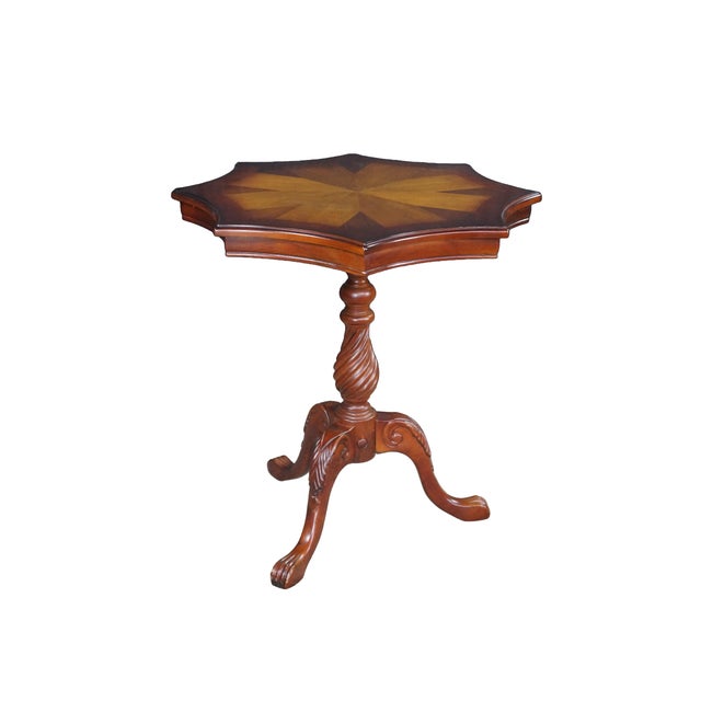Eye-catching vintage mahogany pedestal side table stands on an elegant tripod base featuring carved scrollwork details and...