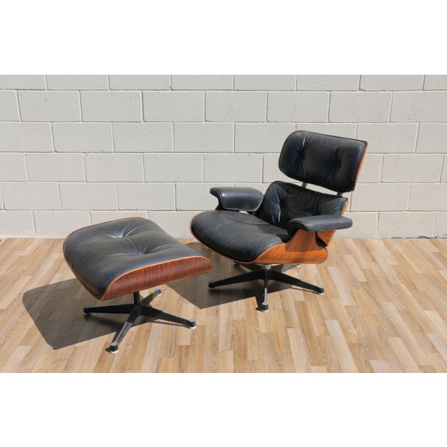 Iconic Eames Lounge Chair and Ottoman by Herman Miller, dating from the 1960s and crafted in richly grained Brazilian...