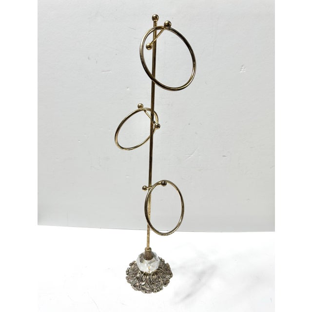 Vintage brass-tone fingertip towel stand with three circular towel holders, ball finials, a faceted clear crystal-style...
