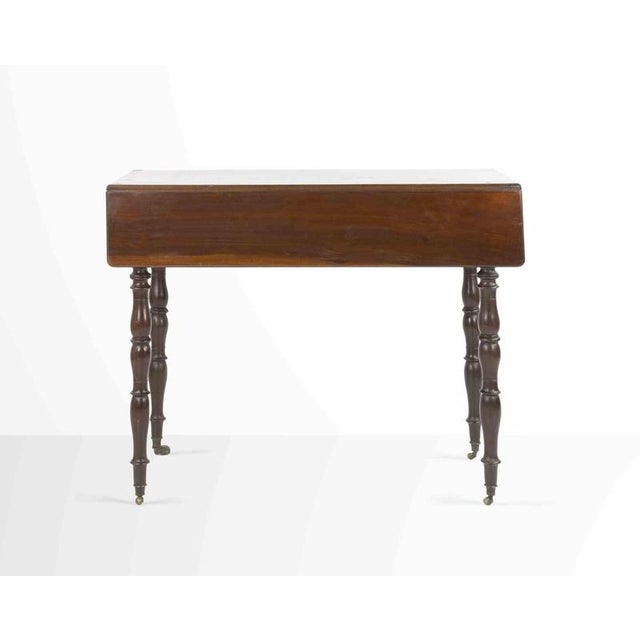 Small solid mahogany side table with side pull and 4 legs with turned columns. Good condition.