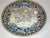 A large Chinese porcelain rose Mandarin charger, hand-painted in enamel colors of royal blue, rose, yellow and teal. It is...