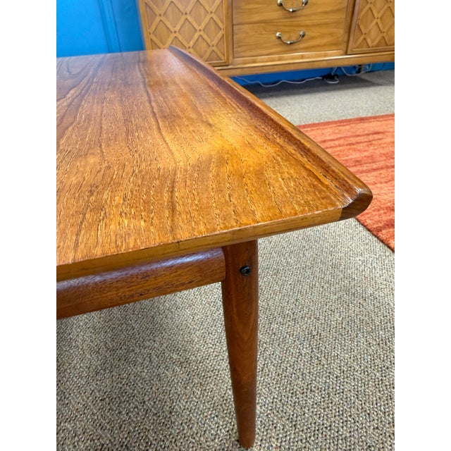 Pair of Mid Century Modern Danish teak side tables by Grete Jalk of Denmark. The tables are crafted from solid teak and...