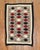 A highly decorative 20th-century American Navajo rug with an all-over geometric tribal pattern on a grey field. Measures:...