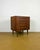A pair of danish chests of drawers, 1960s. Teak frame with tapered, light-colored wood legs. Each drawer features five...