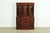 A gorgeous Georgian or Chippendale style breakfront bookcase cabinet with drop front secretary desk In the manner of Baker...