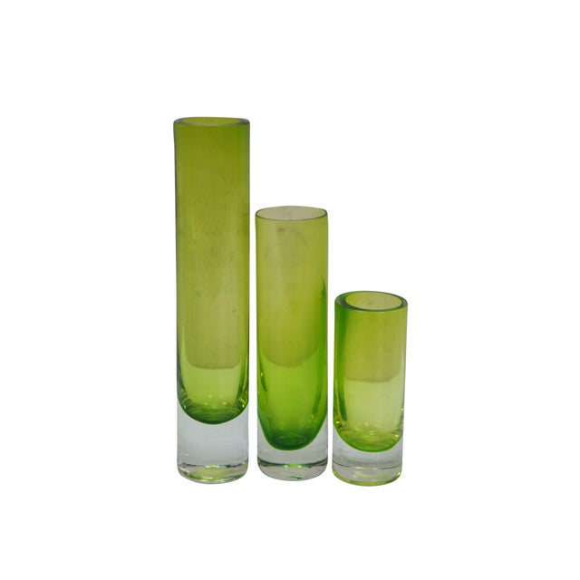 Six vintage hand blown graduated bud vases featuring an emerald green glass in a tubular or torpedo shape. Made by HomArt...