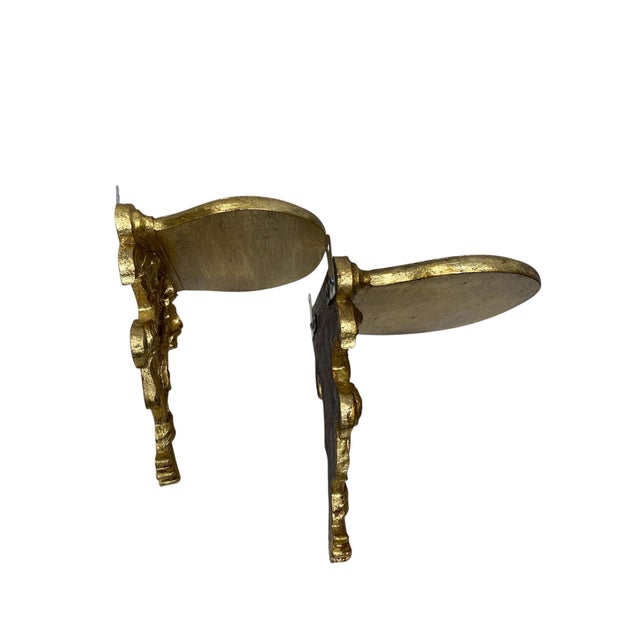 Pair of beautifully gilt and toned wall sconces featuring the Prince of Wales decorative feather plumes. The sconces are...
