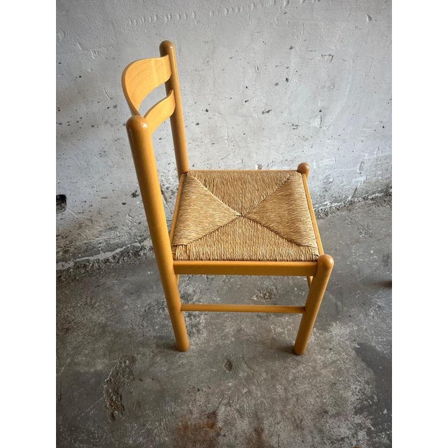 A beautiful set of four italian vintage dining chairs crafted in solid wood with a warm honey-toned finish. These chairs...