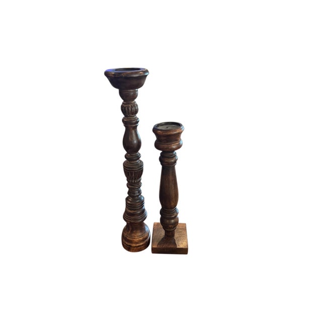 Bring warmth and architectural character to any interior with this striking pair of oversized turned wood candlesticks....