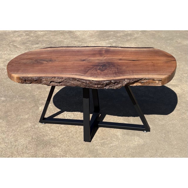 Nice hand made black walnut coffee or cocktail table with live edge and black metal base