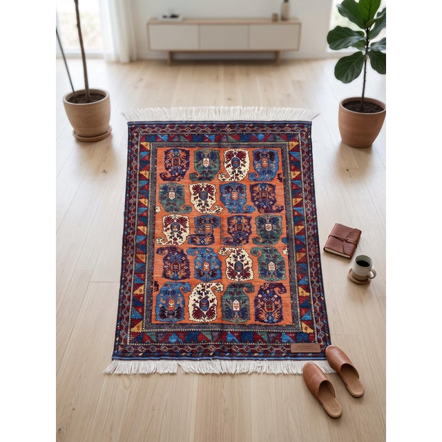 This hand-knotted wool rug reinterprets the classic Persian Bakhtiari garden design, its rust field divided into a grid of...
