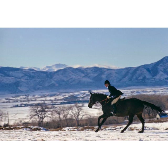 A Horse Ride In The Snow by Toni Frissell A female horse rider gallops across a snowy landscape, 1967. (Photo by Toni...