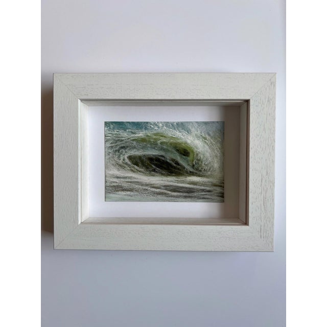 This artwork depicts a dynamic ocean wave rendered in soft pastels, capturing the fluid motion and intricate textures of...