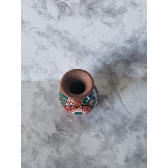 Lovely vintage handpainted miniature Mexican vase. Multicolor florals on terracotta. Perfect on any bookshelf or vignette.