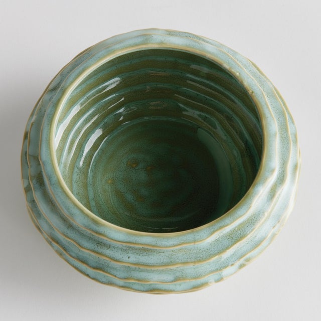 With a reactive glaze and hand finished ribbing detail, this charming sage green bowl is a great find. Add some decorative...