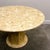 A striking and sculptural 1980s postmodern dining table crafted entirely from breccia marble, featuring a richly textured...