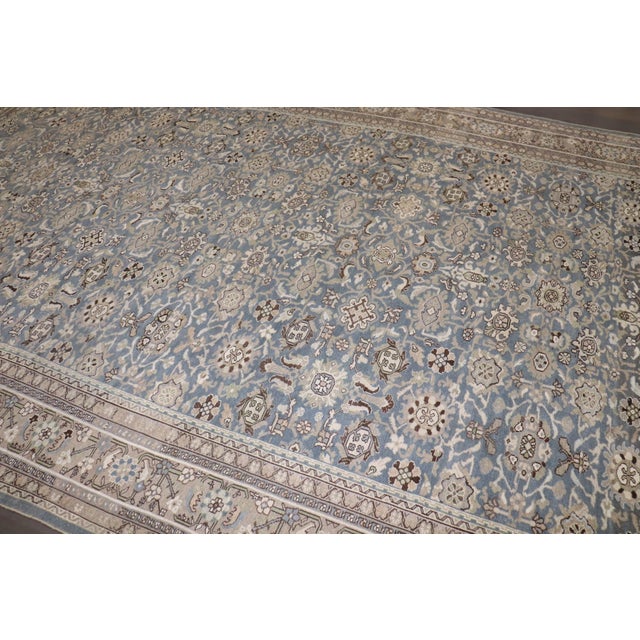 A large blue, earth-toned Persian Malayer rug from the 1930s 10' x 16'9''