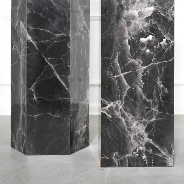 A pair of 90’s pedestals in complementary shapes with formica finish in a dramatic black featuring shades of deep charcoal...