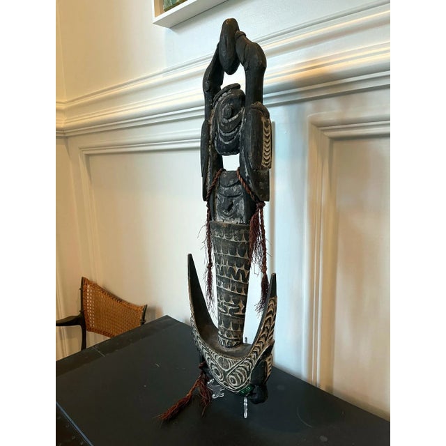 The elaborated carved wood figure with hooks was widely used by indigenous people to suspend items and foods in their huts...