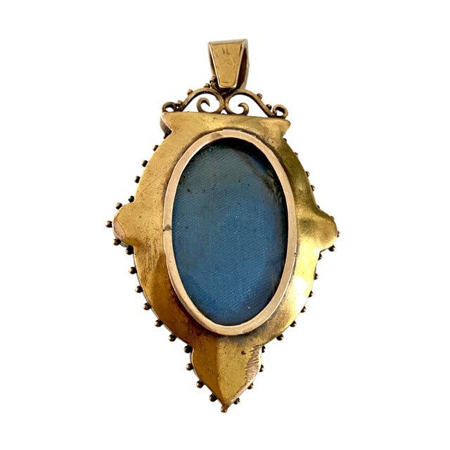 A fine high Victorian period Etruscan pendant/locket c. 1870. The vertical oval locket is surmounted with a large jump...