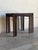 This minimalist nesting table set features three graduated accent surfaces designed to slide cleanly beneath one another....