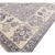 A hand-knotted wool rug in a traditional Oriental design, made in India and measuring 9' x 12'. Floral drawing across the...