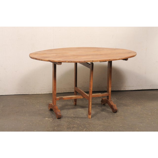 A French wine tasting table, with tilt-style top, from the early 20th century. This antique vintner's table from France...