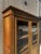 A charming solid walnut display cabinet dating from around 1900, featuring a clean and elegant design typical of French...