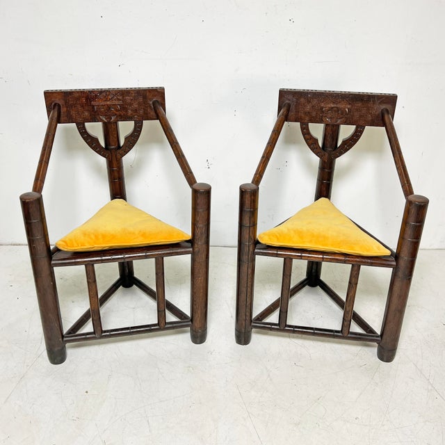 Pair of rustic Swedish munkstolar, or monk’s chairs, ca. 1910-1920. Their three legged design has its origins in the...
