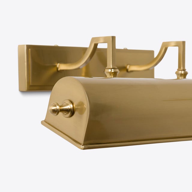 The Putney picture light, seen here in brass is a larger version of our Richmond light. Two arms support a trough style...