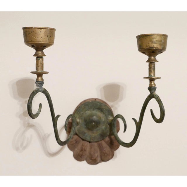 A pair of antique Anglo-Indian candle sconces, hardwood shell form backplate issuing bronze scrolled candle arms. These...
