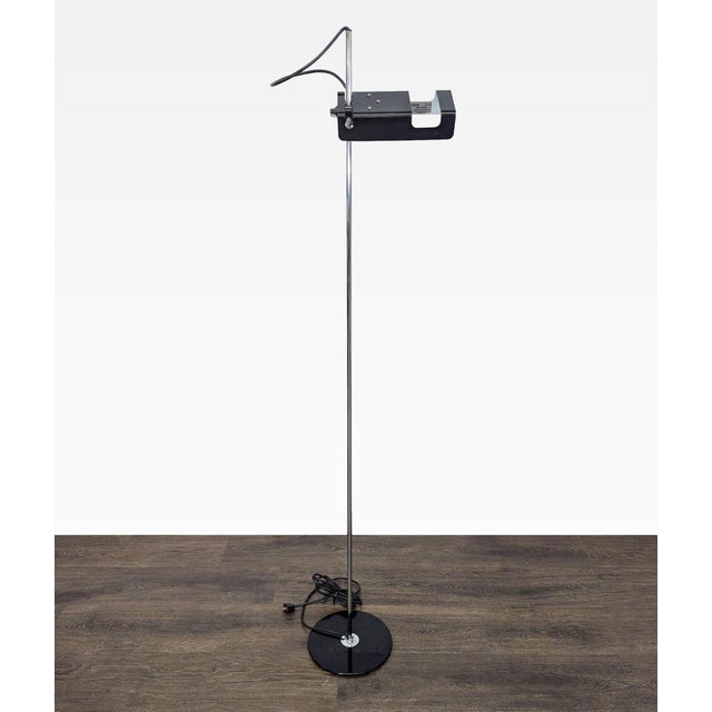This is a stylish floor lamp by Joe Colombo for Oluce. It features a slim chrome pole, a sturdy black base, and a unique...