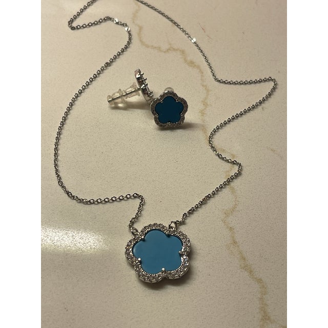 Turquoise famous shape pendant set surrounded by cz's with silver chain 1' wide 16" long
