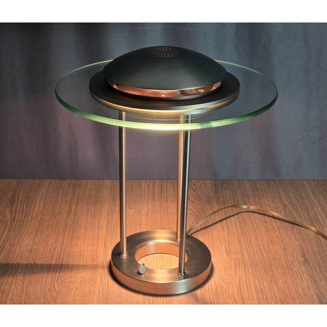 Glass and brushed metal finish on this Saturn or flying saucer style table lamp. Nicely made, dimmer switch and overall,...