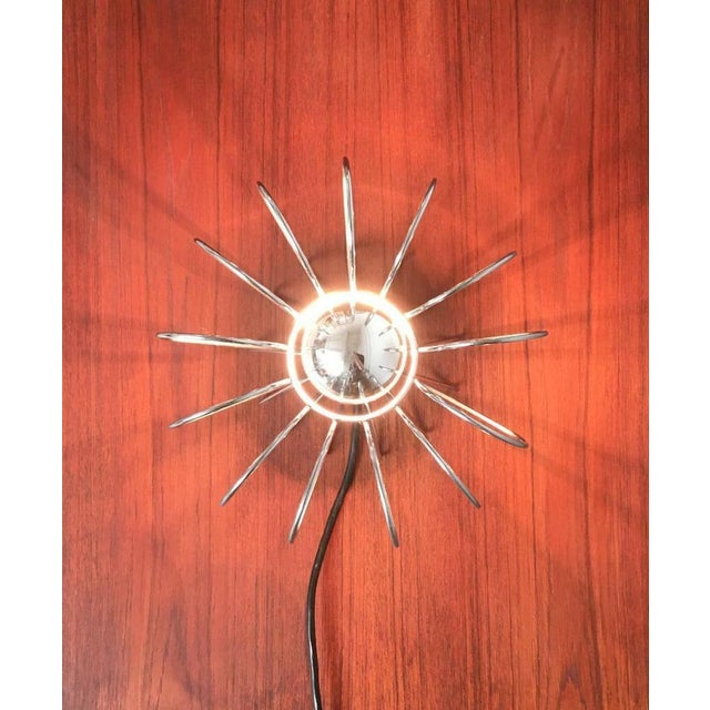 Mid-Century table lamp with transparency. The luminaire body is almost completely dissolved in wire elements. These form...