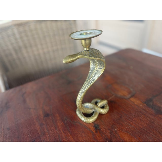 Here is an amazing weighty Mid Centuryi incised brass cobra candle holder. Has a lot of detail and makes a statement!...