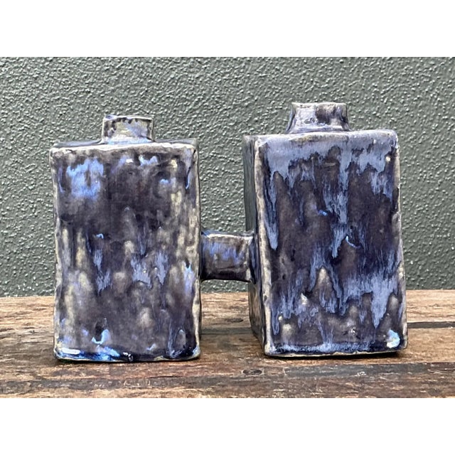 This vintage dual cubic ceramic vase presents a striking sculptural form made from two interconnected rectangular bodies,...