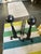 A pair of antique cast iron Federal style andirons with tall ball-top finials, cabriole legs and scrolled feet. Set on a...