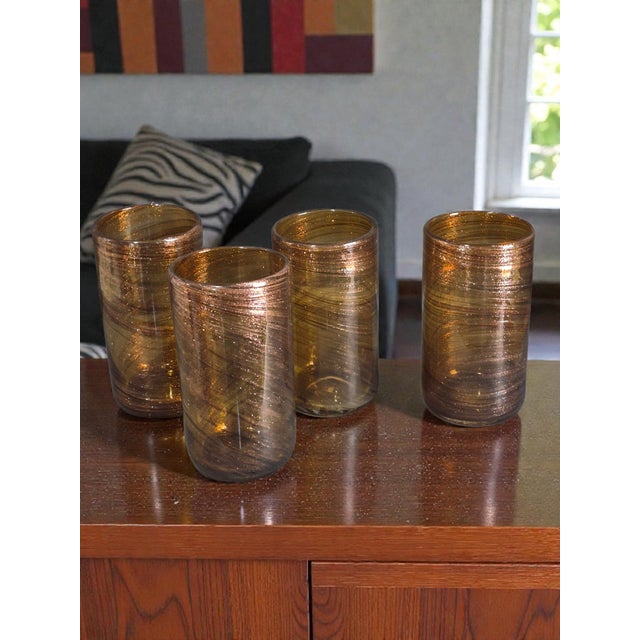 These hand-blown art glass tumblers are a stunning example of Mid-Century Modern design, featuring a swirl pattern in a...