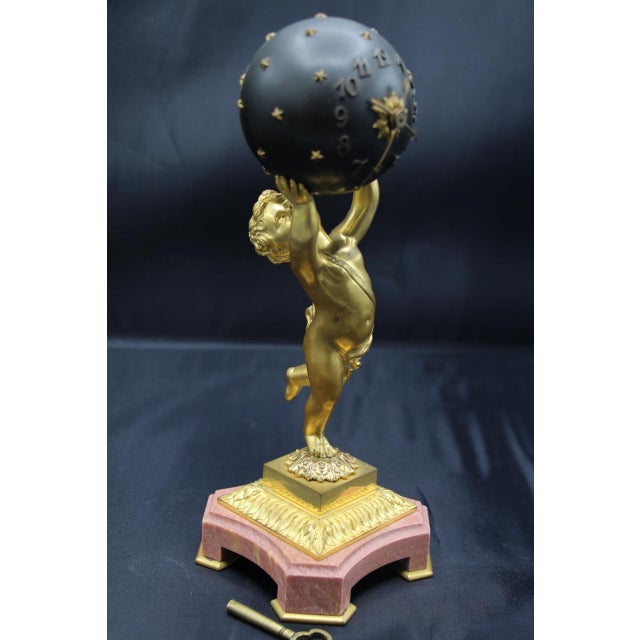 Small, mysterious 19th-century clock in patinated and gilded bronze on a marble base made by Ferdinand Gervais in Paris in...