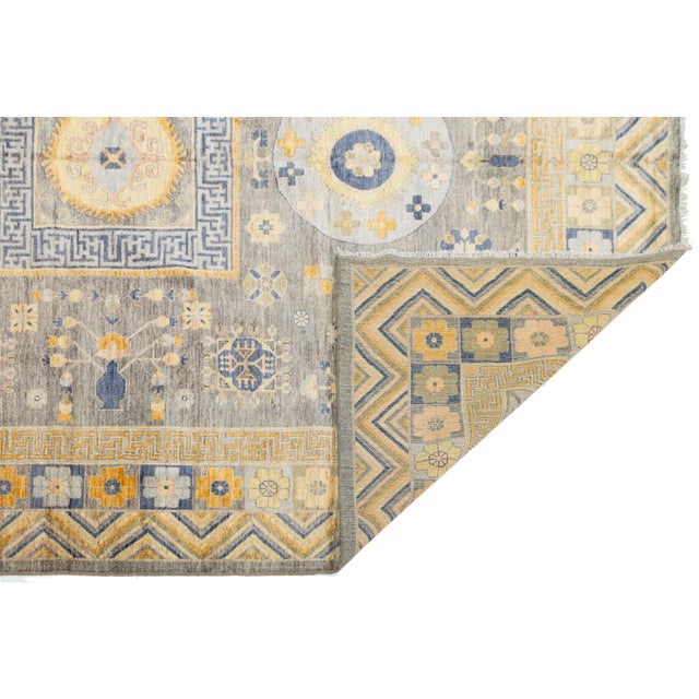 This hand-knotted wool rug beautifully merges East Turkestan artistry with a modern slate grey color palette. It features...