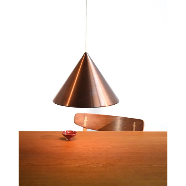 Brushed copper conical pendant lamp, "Biljard" model by Arne Jacobsen for Louis Poulsen. Featuring a conical silhouette in...