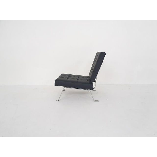 Metal frame and cushions reupholstered in black leather.AP originals was a furniture manufacturer from the Netherlands...